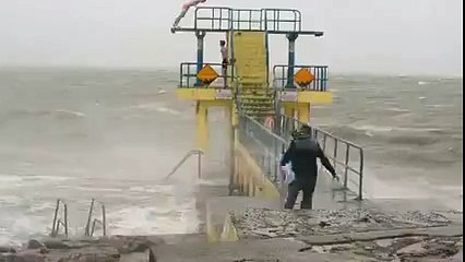 Youths Slammed for Diving Into Choppy Waters Amid Storm Conditions