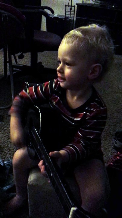 Baby Plays guitar and singing. ..