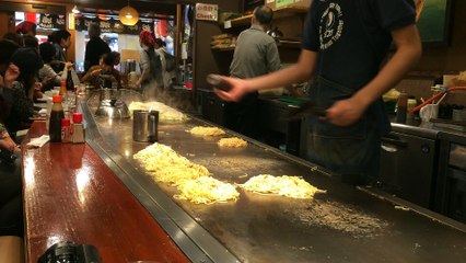 They're cooking an Okonomiyaki.