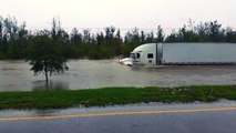 18 Wheeler Plows Through Flood Waters