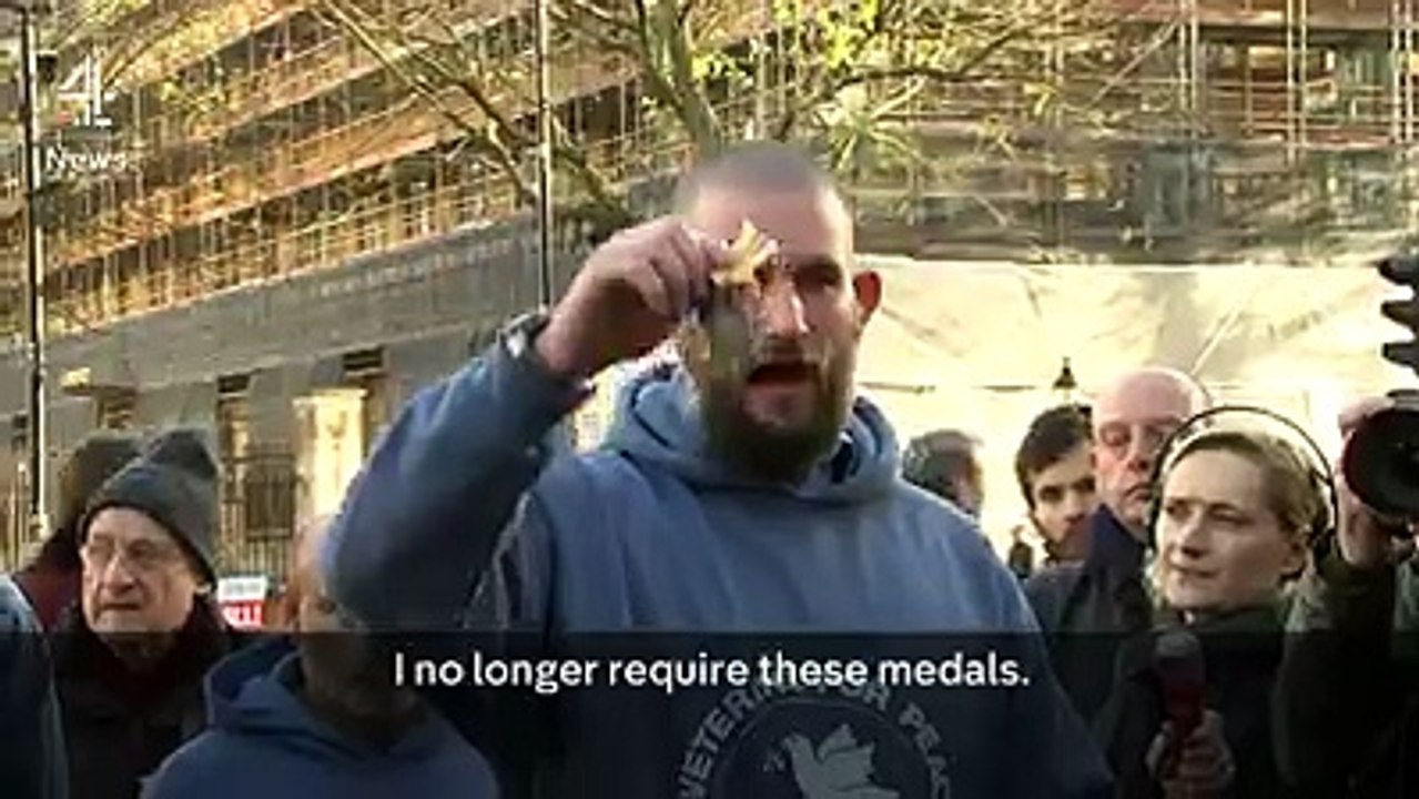 A small group of British military veterans throw off their medals outside Downing Street in protest at the bombing in Syria.