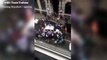 Incredible moment crowd lifts taxi to rescue trapped woman