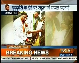 Narayanasamy holds slippers for Rahul Gandhi
