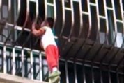 VIDEO: Tots life in the balance as he dangles from third floor balcony – with his HEAD