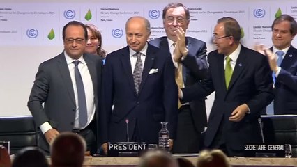 Delegates celebrate as historic climate pledge adopted