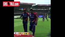 Chris Gayle chases Yuvraj Singh with his bat.