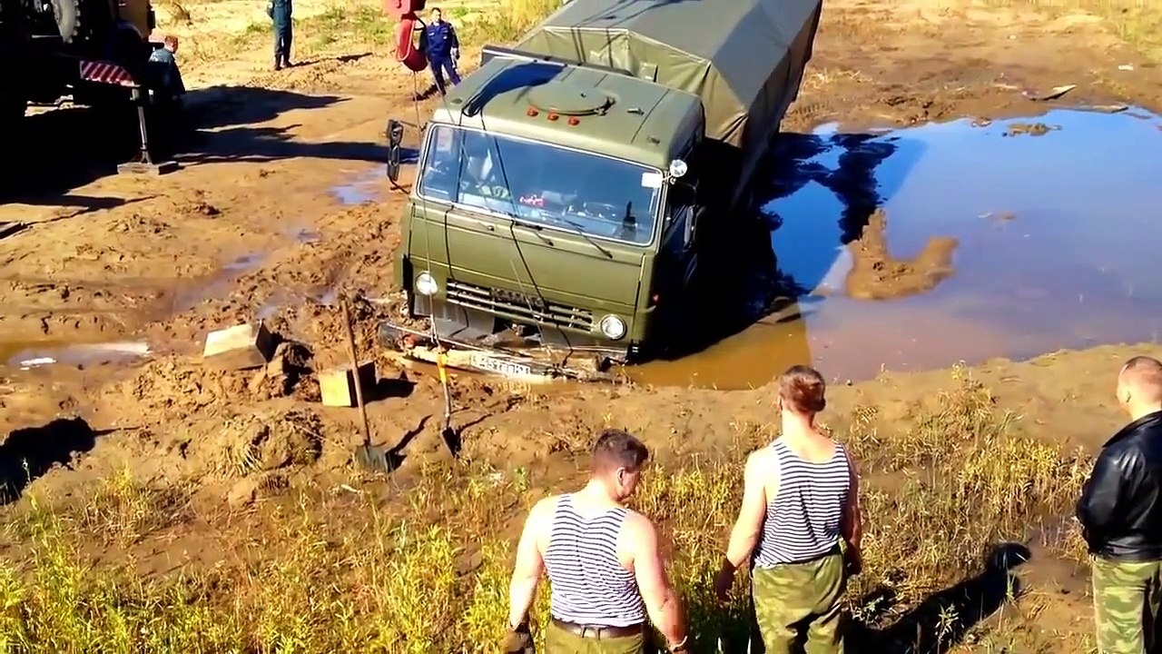 A Russian tractor driver refuses to give up after his vehicle gets stuck in a river.