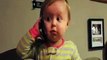 Cute little baby talking on phone with his daddy in his language
