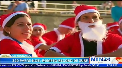 Récord Guiness: más de 300 Papás Noel surfearon en Australia