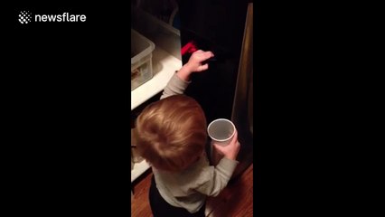 Cute toddler just can't work out the water dispenser