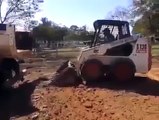 Professional driver loads compact track loader into truck