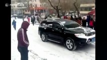 SUV slides back down hill amid China snow