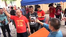 Supporters counter coffin for DAP MP with 'RM2.6b' placards