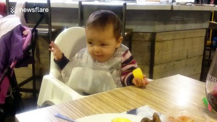 Baby pulling a funny face after eating a lemon