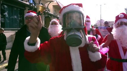 Palestinians demonstrate dressed up as Santa in Bethlehem