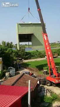 Crane tipping over after lifting a building... FAIL