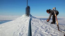 US Navy Sailors Using a Chainsaw to Release a Submarine Blocked by Ice in Artic