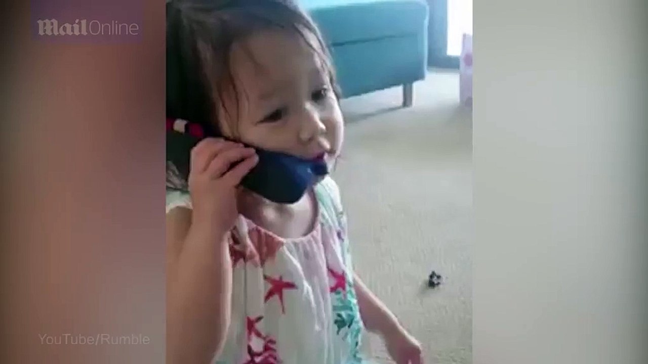Adorable little girl uses a slipper as a phone