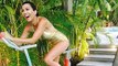 Kourtney Kardashian Shows Ample Cleavage In Golden Swimsuit