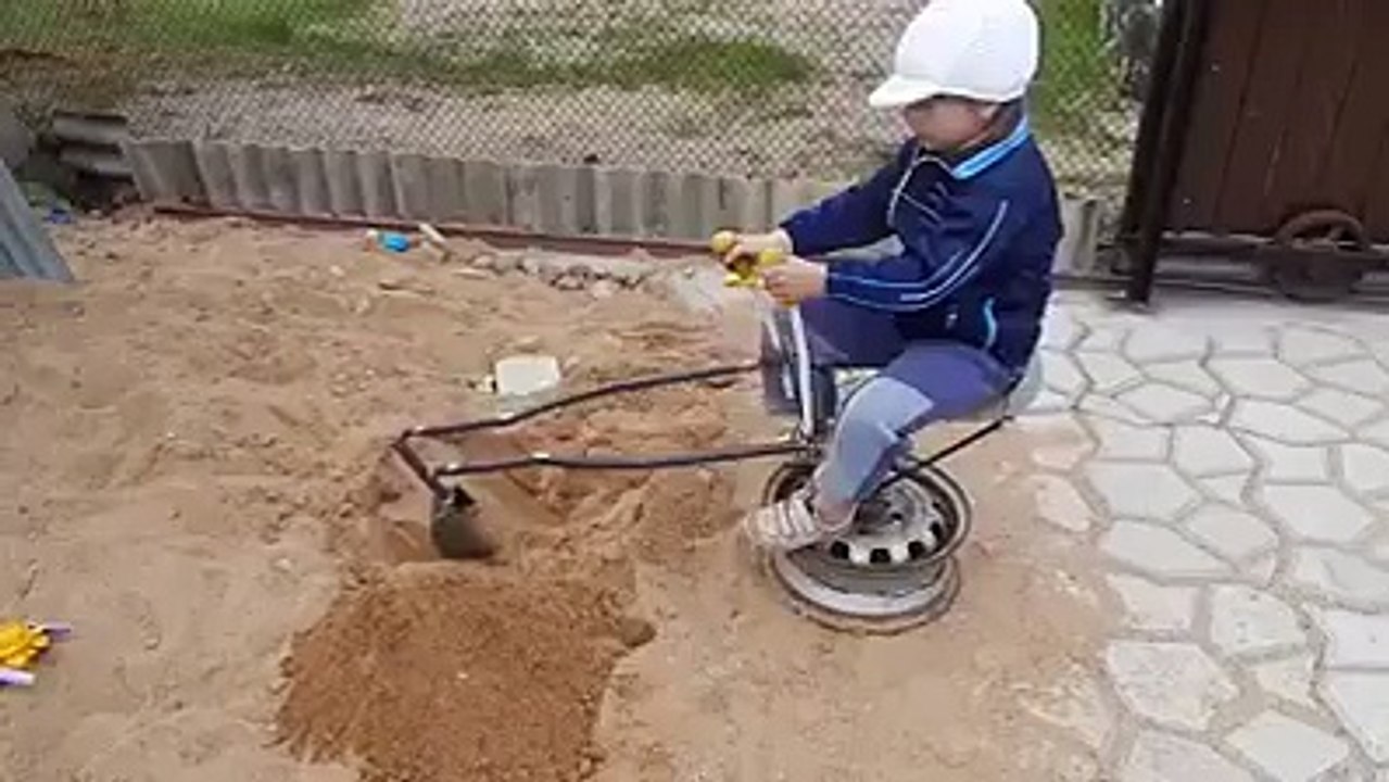A Little Boy Operating Hand Made Bulldozer