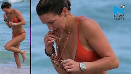 Katie Cassidy flaunts beach body in orange bikini