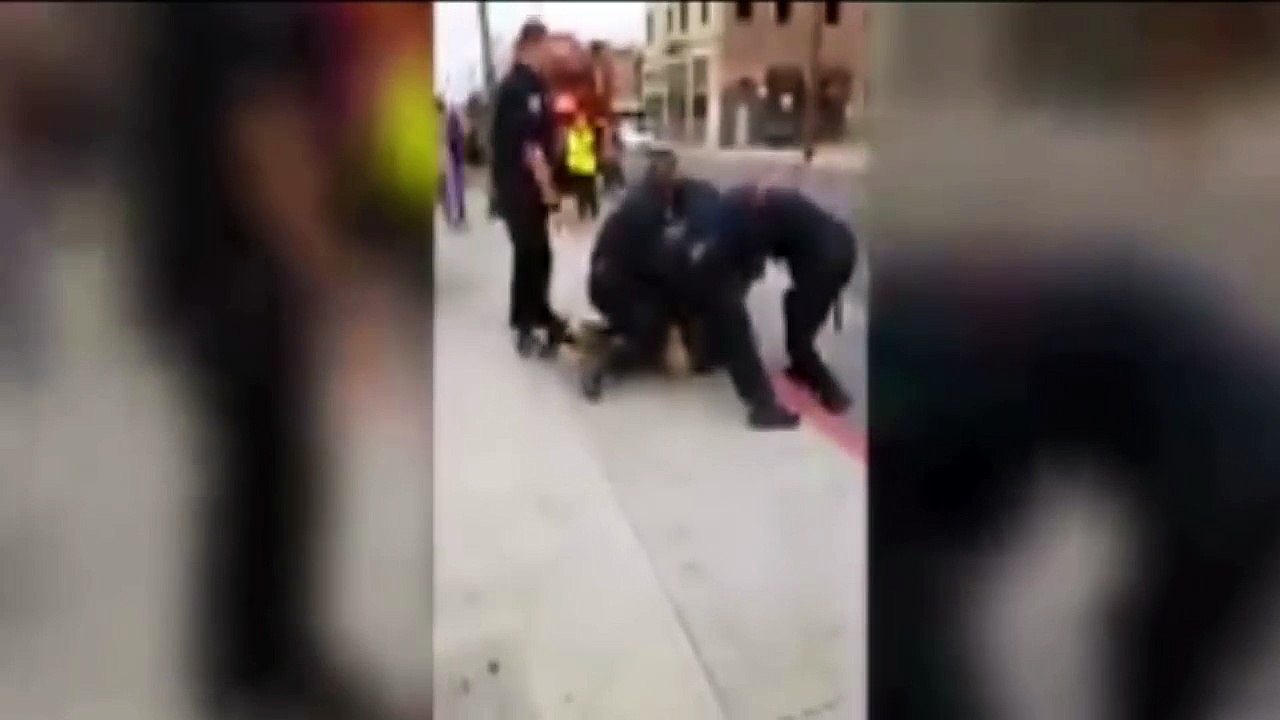 Nine officers arrest one teenager  for jaywalking  after cop beats him across face with baton