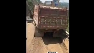Truck falls off road in China