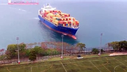 Container ship sails straight to shore by university football field