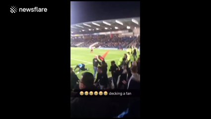 Goalkeeper 'decks' fan after 'pitch invasion'
