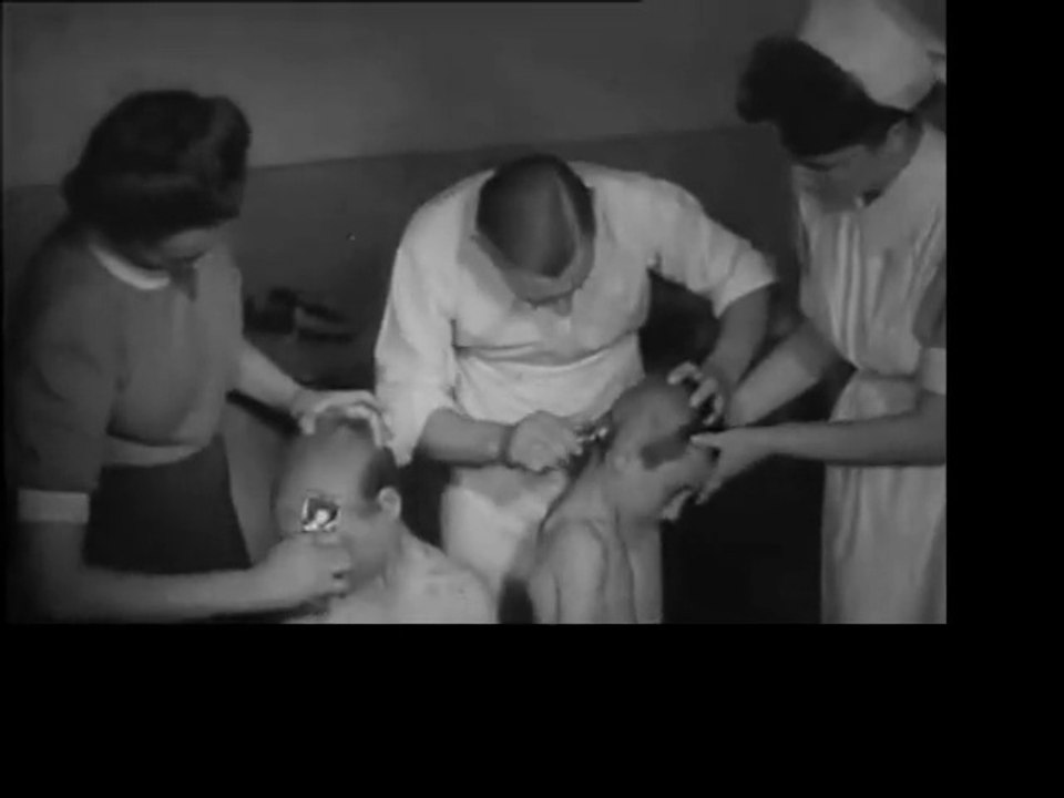 refugees get hand clipper haircuts during 1940s