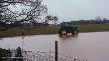 Randy waterskis behind d a TRACTOR in flooded field