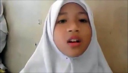 A girl reciting Quran with a beautiful voice