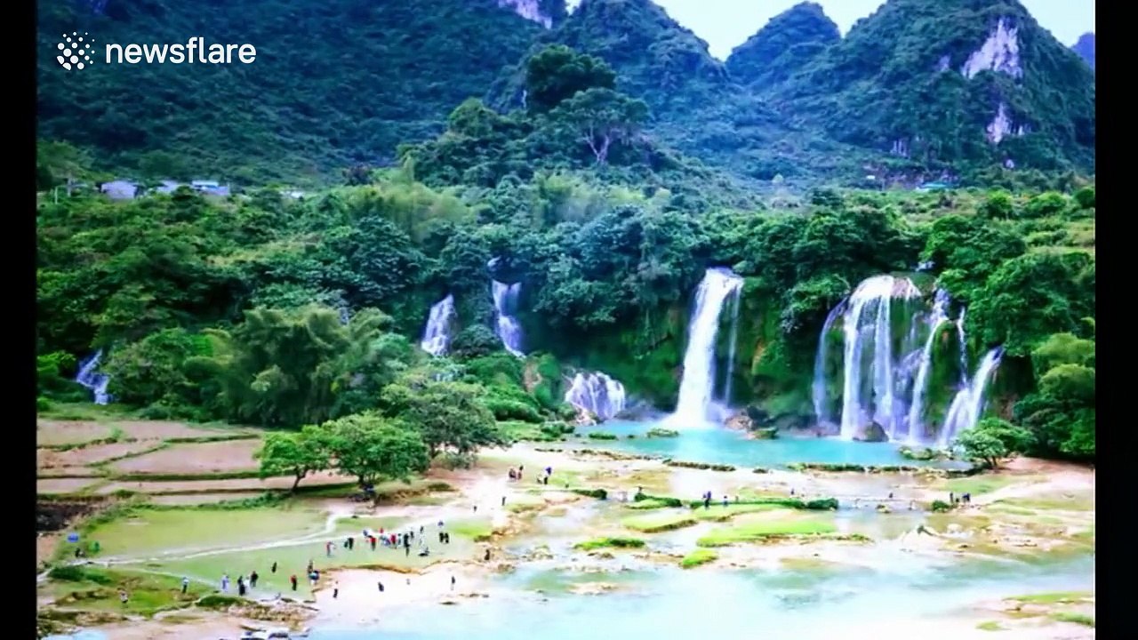 Beautiful drone footage of water rushing off Detian waterfall