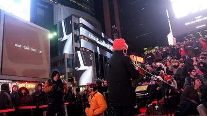 Laurie Anderson watches her film on Times Square billboards