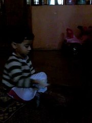 This two year old girl making chapati.