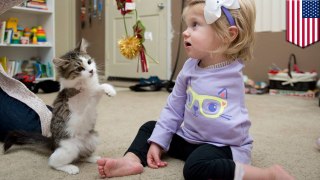 Little girl missing an arm and kitty missing a leg become best friends