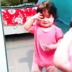 Little girl putting a crown on his head