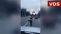 Bizarre moment woman strips in middle of road and dances for cars in sub-zero temperatures