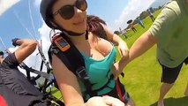 Une femme en décolleté filme son vol en parapente..
