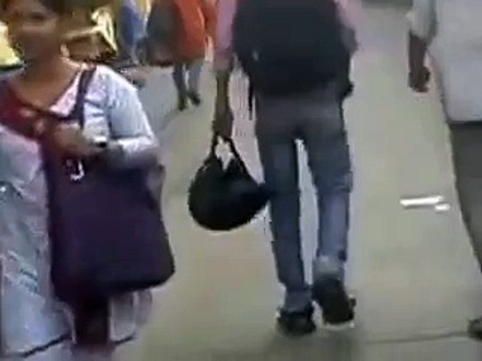 People are busy talking in the phone while walking on the road