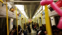 Balloon animals tied to the poles in London Underground train