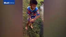 Talented boy goes fishing with a toy pole and catches a fish