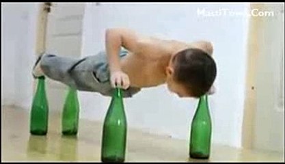 Small Boy Doing Push Ups on beer bottles