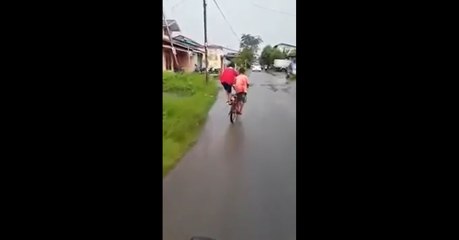 2 children with 1 bike trails. The combination of the two boys rhythm is a fun example of teamwork.