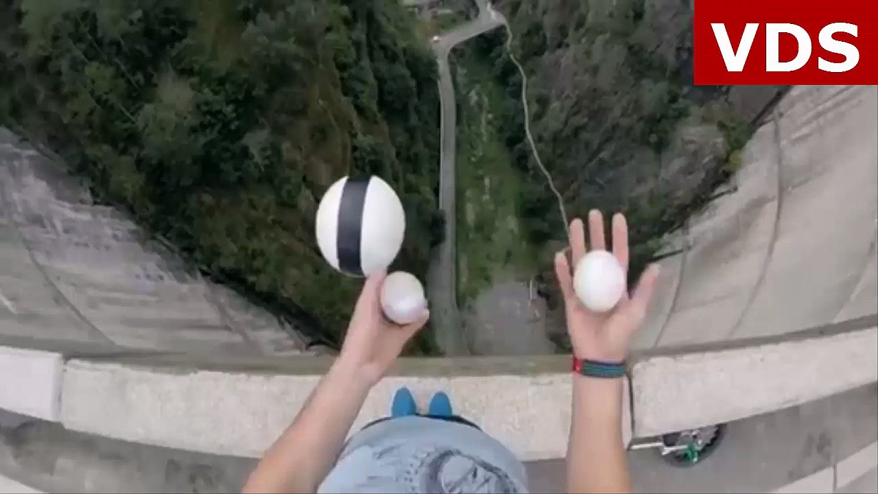 Watch juggling daredevil unicycle along wall of 500ft dam in dizzying first person video