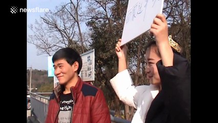 Girl holds up placard in attempt to find boyfriend for Chinese New Year