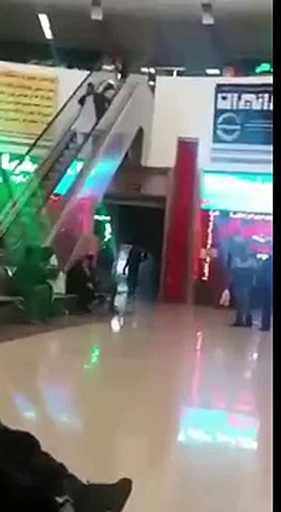 Arab on escalator