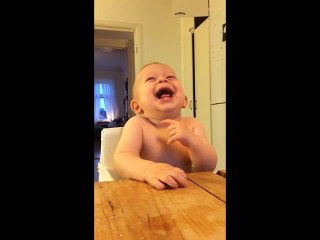 Baby laughing hysterically at coconut