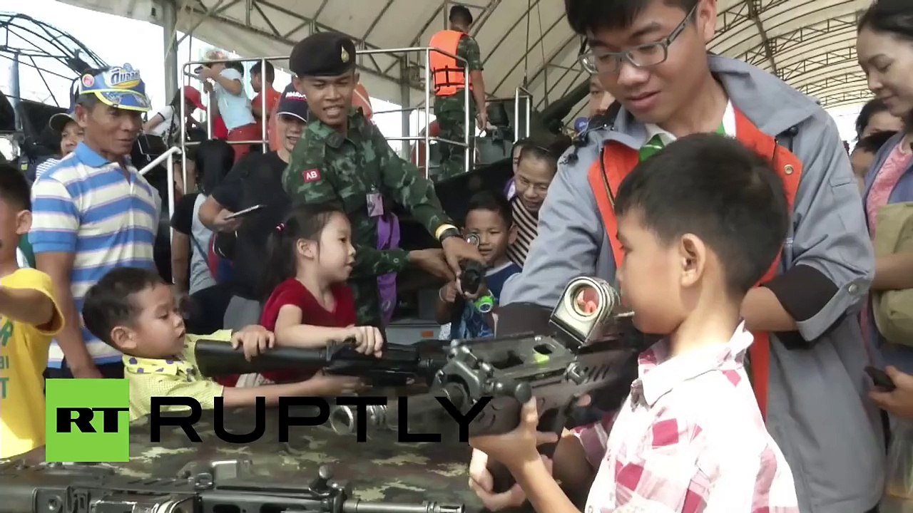 Thailand: Kids play with army weaponry on Childrens Day