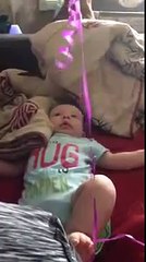 Cute Baby Laughing At Balloon Tied With His Leg